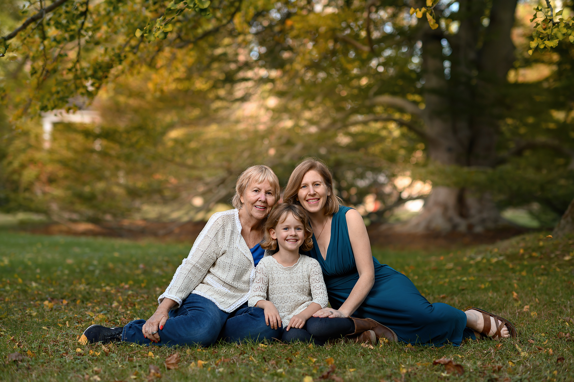 3 generations of mothers and daughters sitting in a park