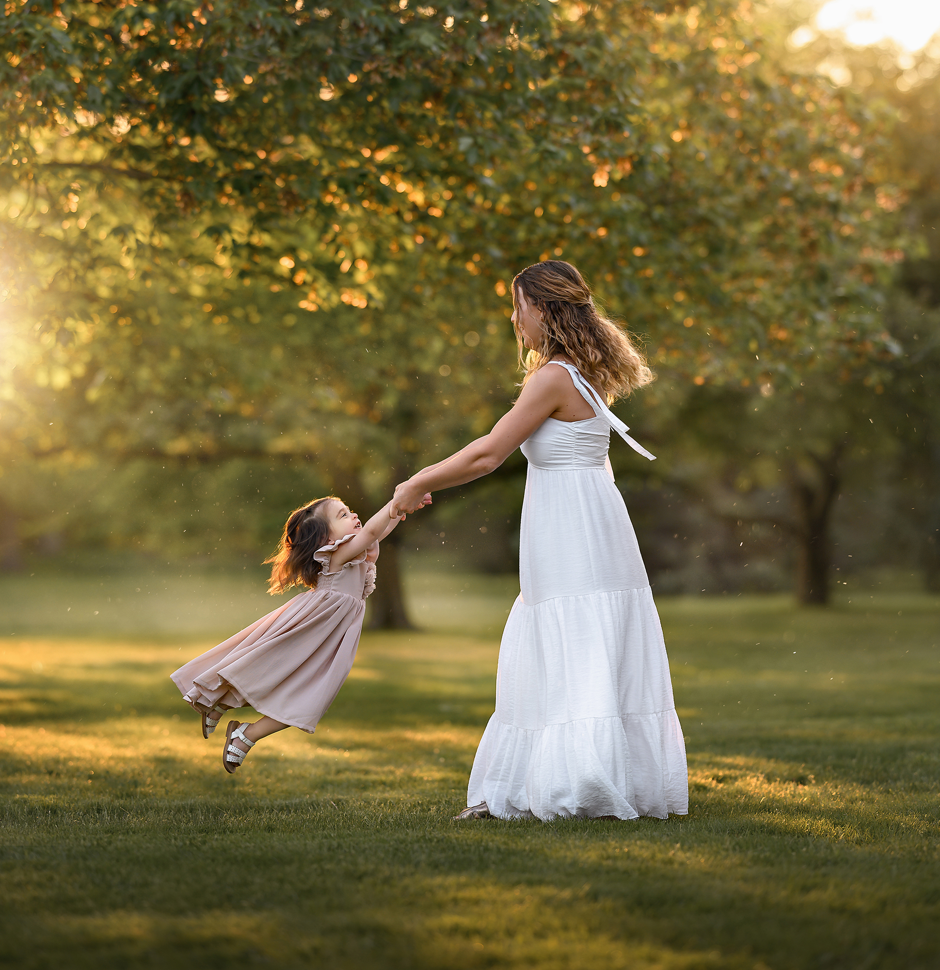 mom swinging her daughter around at chesapeake parks