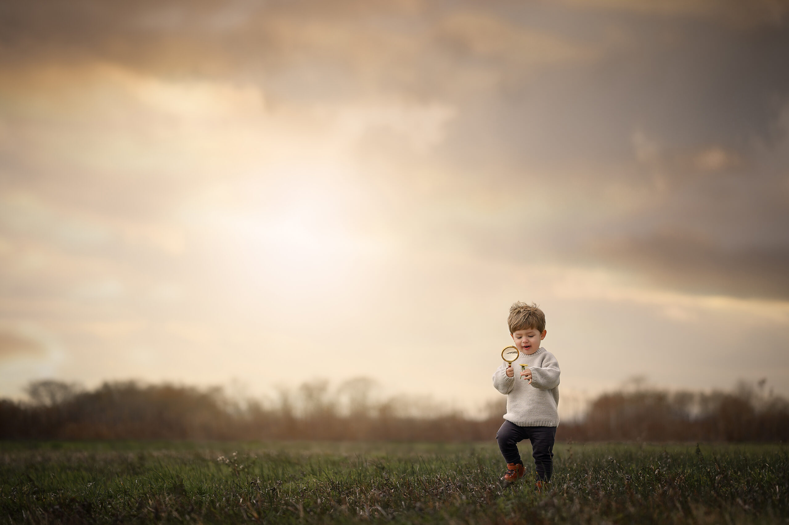 Litlte boy running through a field with an open sky behind him Military Aviation Museum